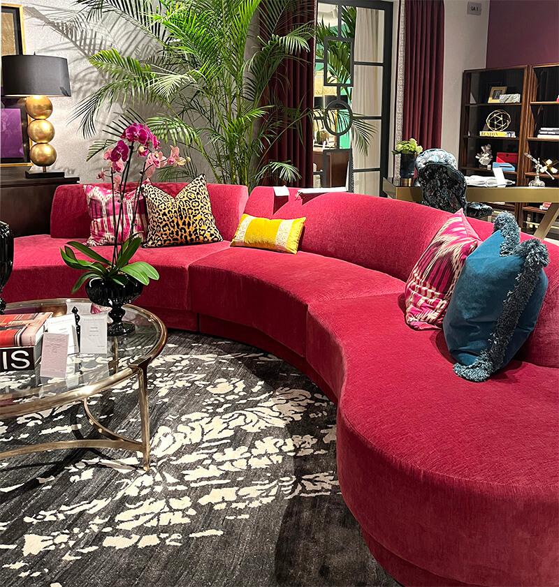 Bright pink modern curvy sectional with yellow and teal accent pillows